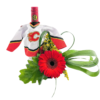 A 2020 Malbec bottle wears a tiny Calgary Flames hockey jersey, its neck peeking out of the little red-and-white sweater emblazoned with the “flaming C” logo. Tucked alongside the jersey is a bold red gerbera daisy set against a large, lobed green leaf. Looped blades of lily grass form a heart-shaped accent to the right, while clusters of small yellow blossoms fill in behind the daisy, all resting atop a backdrop of broad tropical foliage. The overall effect is a playful nod to both wine and hockey, united by a single striking red bloom.