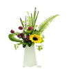 A tall, white tapered vase holds an asymmetrical floral arrangement featuring a large yellow sunflower at center right; clustered deep burgundy spray roses; unopened blue iris and lily buds rising above; delicate pink waxflower; bright green fern fronds; and a single large, curved leaf, all interspersed with assorted greenery.